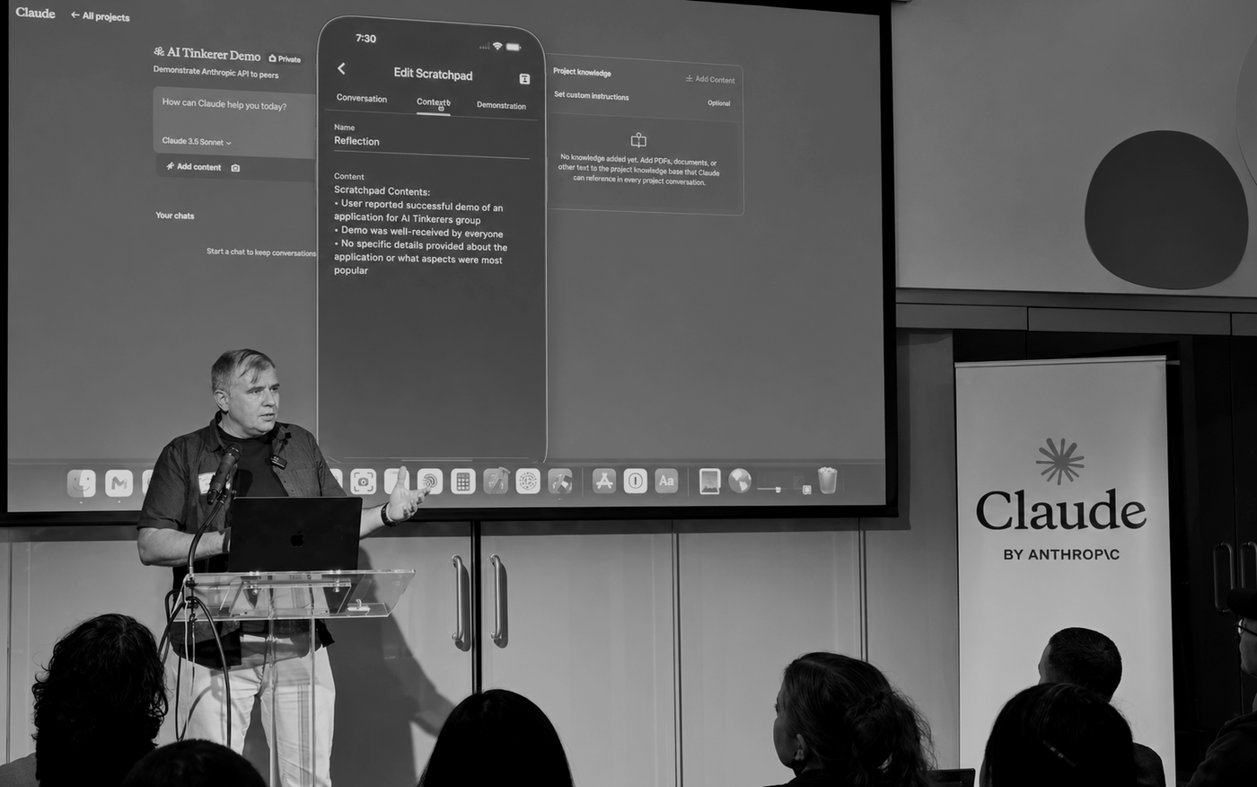 Speaker presenting an AI Tinkerer demo on stage.